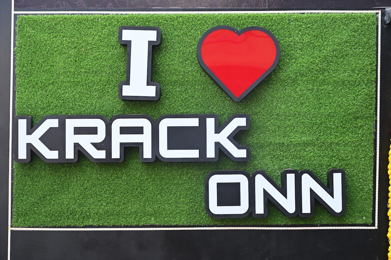 I love Krackonn sign on green background
